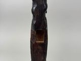 an old wooden statue of a woman holding a baby
