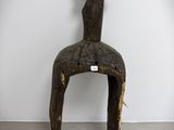 a wooden sculpture of a bird sitting on a chair
