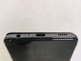 the back of a black cell phone with a camera on top of it