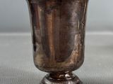 a silver cup sitting on top of a table