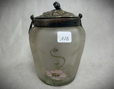 a glass jar with a bird on it on a table