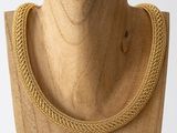 a close up of a necklace on a mannequin mannequin