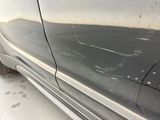 a close up of a car ' s front bumper with a denting on it