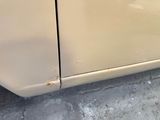 a close up of a car with rust on the side of it