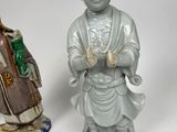 two figurines that are sitting next to each other