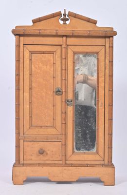 a small wooden cabinet with a mirror on it