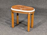 un petit tabouret en bois avec une assise en cuir