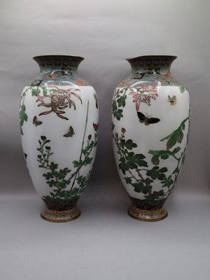 two vases sitting next to each other on a table