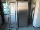 a silver refrigerator and a metal rack in a room