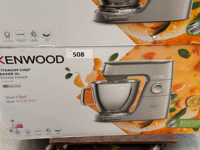 two boxes of kenwood stand mixers sitting on top of each other