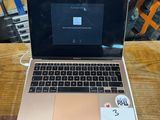a laptop that is sitting on a table in front of other laptops
