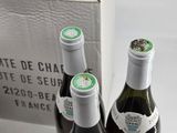 two bottles of wine sitting next to each other on a table