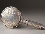 a silver mirror that is sitting on a table