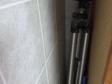 an image of a toilet with a tripod in the corner