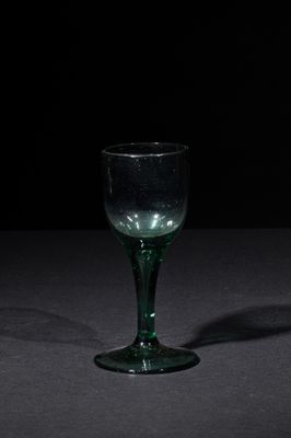 a wine glass that is sitting on a table