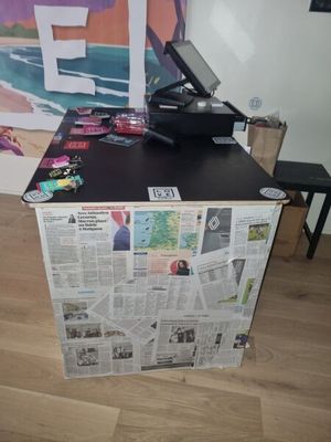 a laptop computer sitting on top of a newspaper box