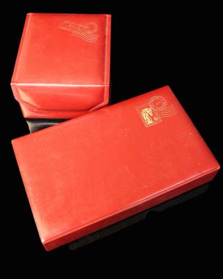 two red boxes that are sitting on a black surface