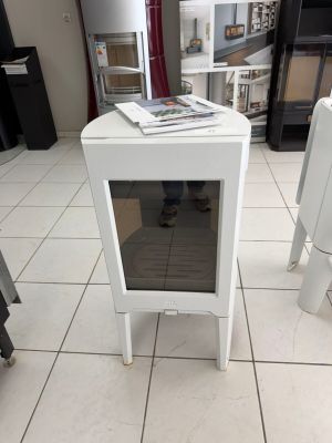 a small white table with a glass door in the middle of the room