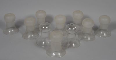 a lot of glass candles that are sitting on a table