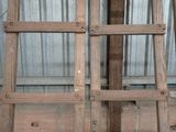 two wooden ladders sitting next to each other