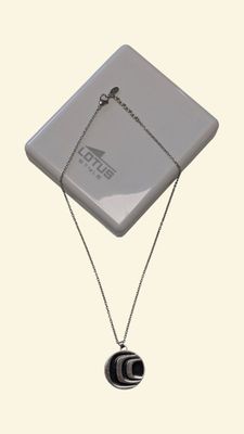 silver plated necklace with a black and white pendant on a silver chain