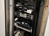 a rack with many electronics in it in a room