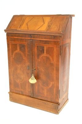 a wooden cabinet with a door and a bell on it