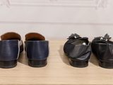 three pairs of shoes are lined up on a wooden table