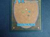 a close up of a card on a table with a blue background