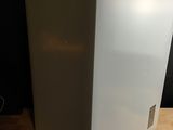 a white refrigerator sitting on top of a wooden table