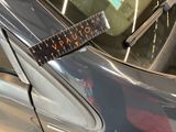 a ruler on the windshield of a car that is parked in a garage