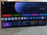 a flat screen tv sitting on top of a wooden table