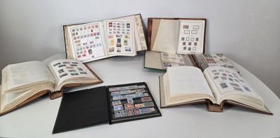 several open books sitting on top of a table with stamps on them