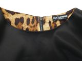 the back of a black dress with a leopard print collar