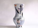 a white vase with a picture of a woman on it
