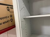 a white shelf with a box on top of it