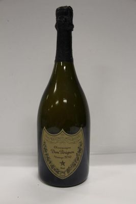 an old bottle of champagne sitting on a white surface