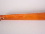 a wooden pipe that is on a white surface