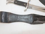 a knife and a belt laying on a table
