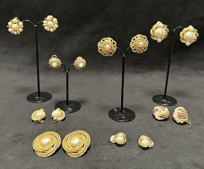 a lot of gold jewelry on display on a black table