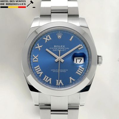 a close up of a watch with roman numerals on the face