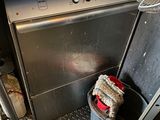 an image of a dirty kitchen with a dishwasher and a trash can