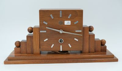 a wooden clock that is sitting on top of a table