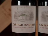 two bottles of wine sitting next to each other on a table