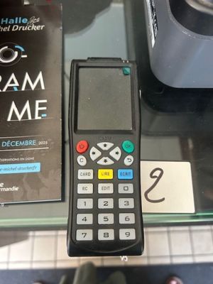 une télécommande posée sur une table en verre à côté d'un livre
