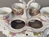 a picture of a porcelain tea set with cups and saucers