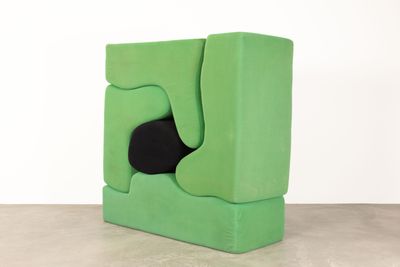 an image of a green chair with a black cushion on it
