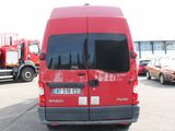 a red van that is parked in a parking lot