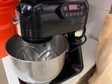 a black mixer on the counter in the kitchen