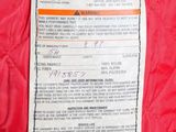 the label on the back of a red quilted jacket